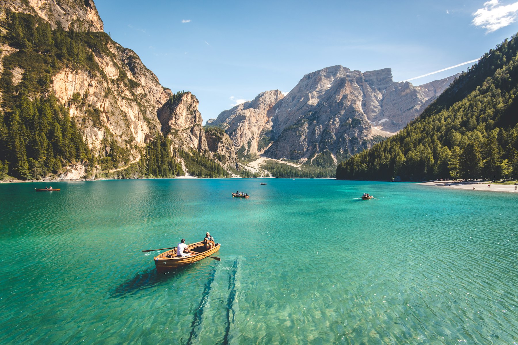 Wooden boats on a clear mountain lake