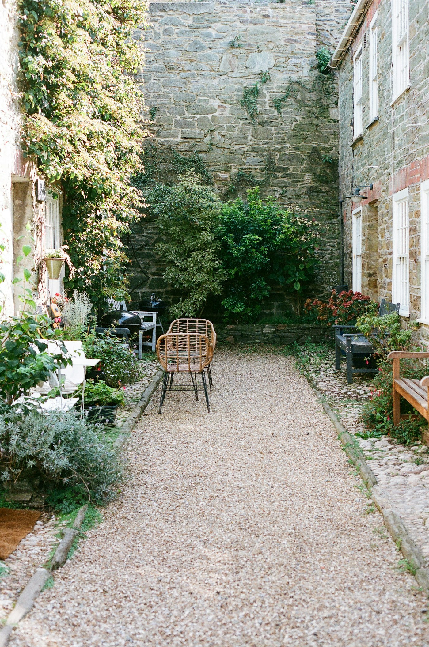 A stone archway onto a cobbled courtyard