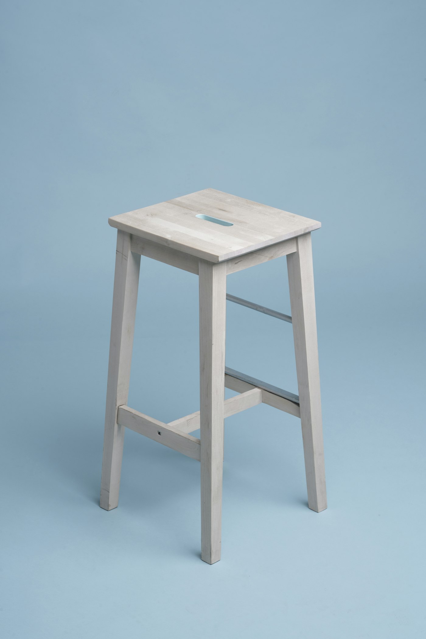A mustard lounge chair beside a side table