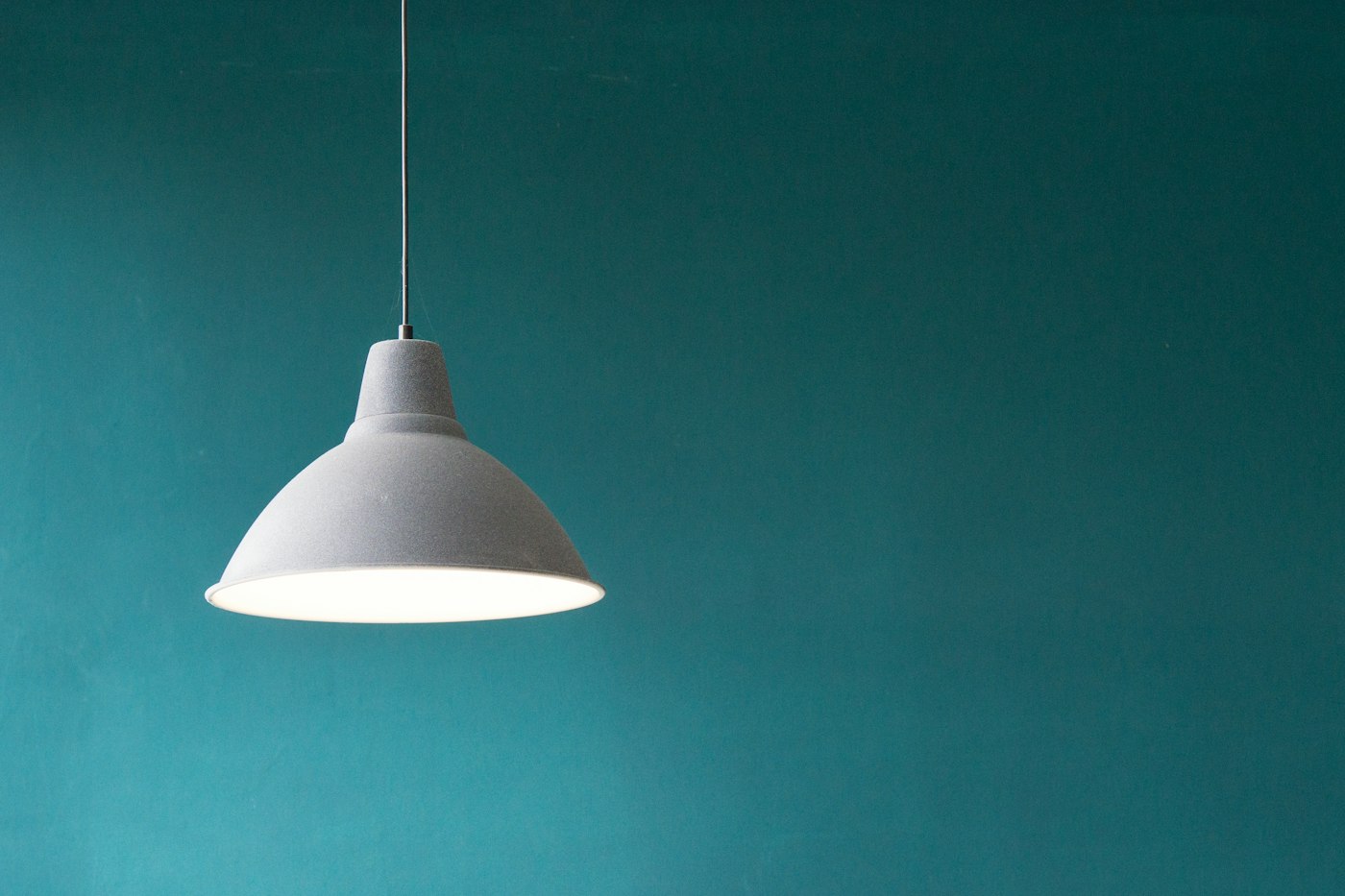 A grey floor lamp with an angled shade