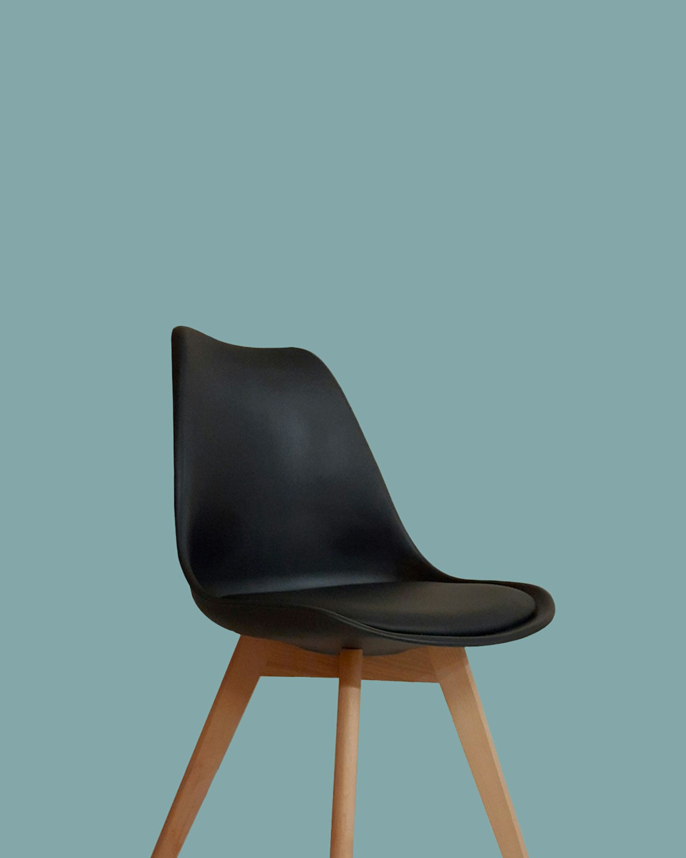 A mustard lounge chair beside a side table