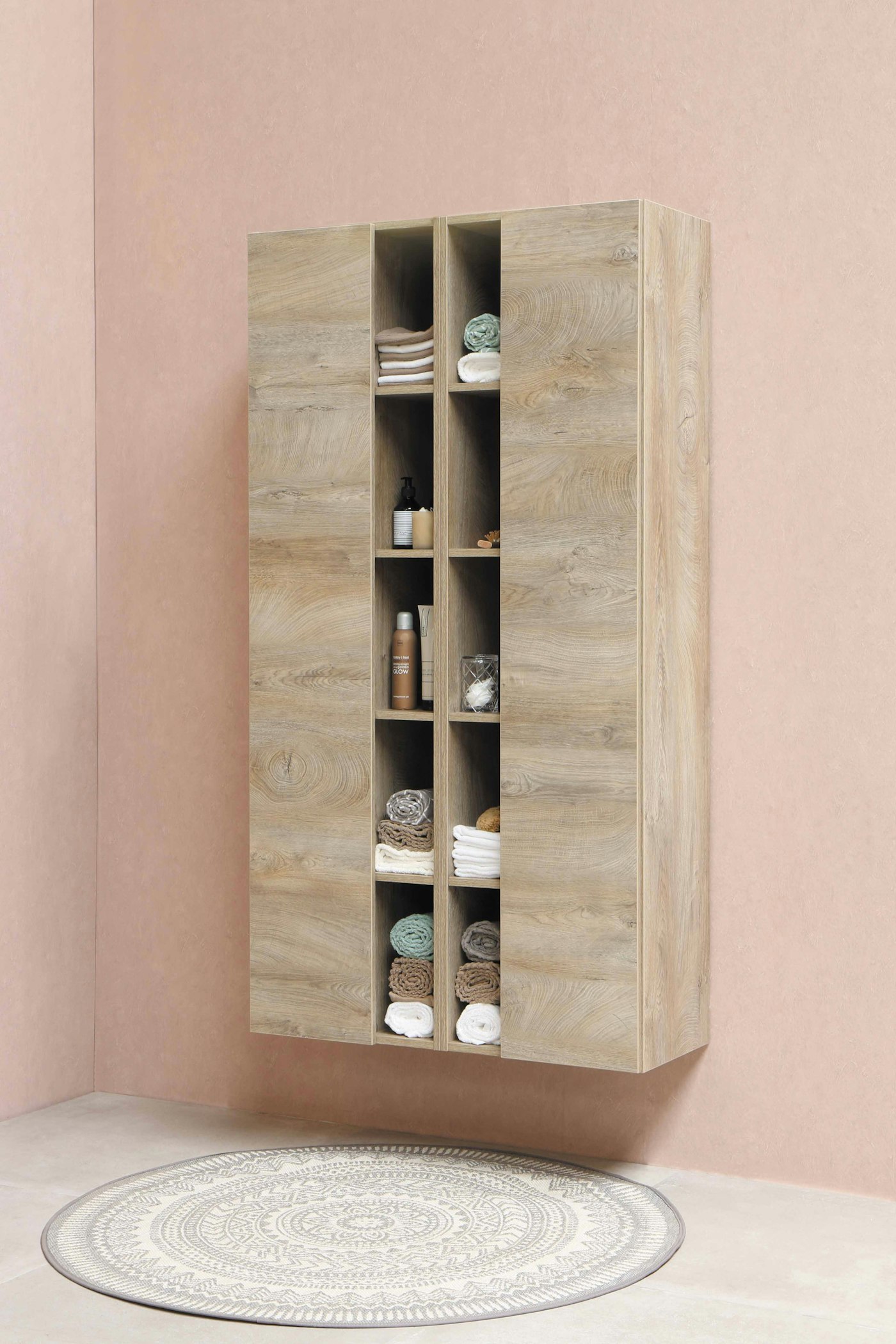 A tall wooden shelving unit on a pink wall