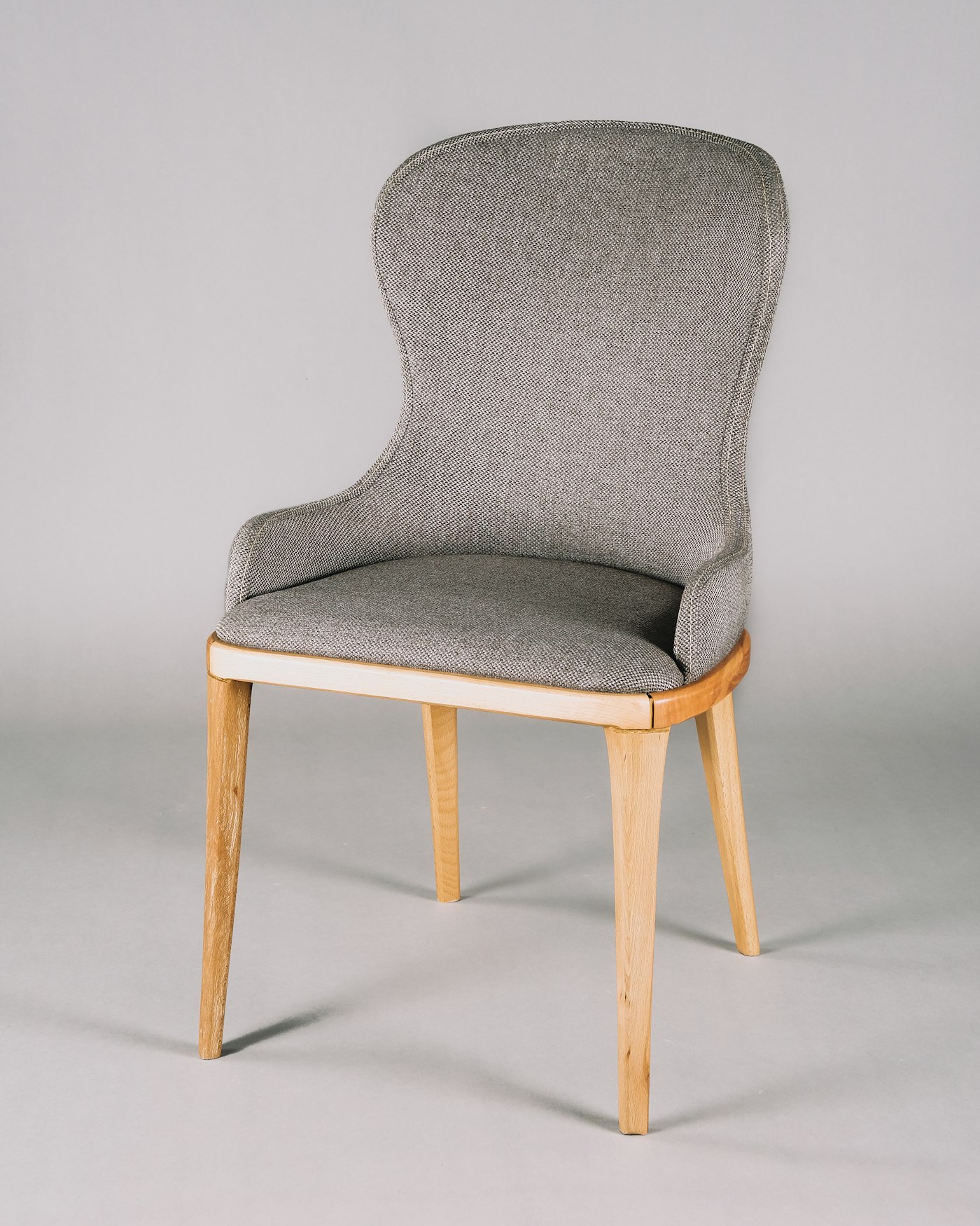 A mustard lounge chair beside a side table