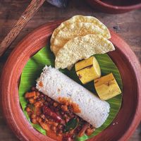 Puttu with kadala curry and banana on a leaf