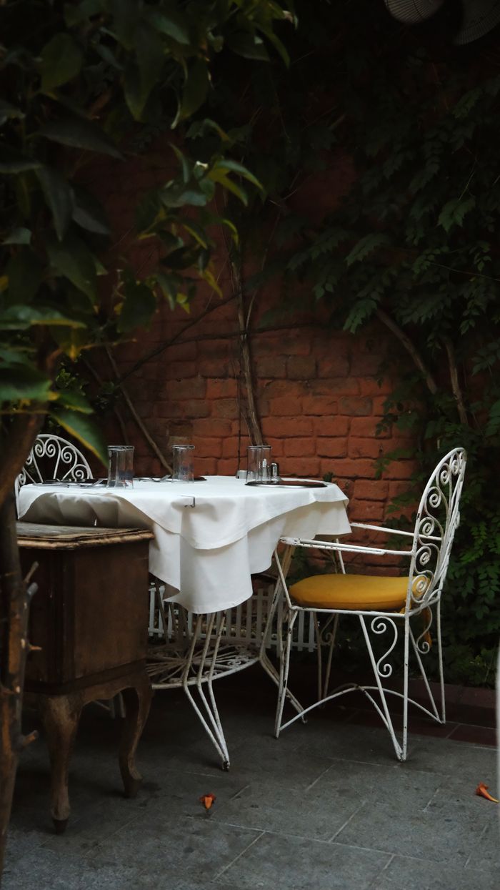 A dinner table laid in the garden for a private party