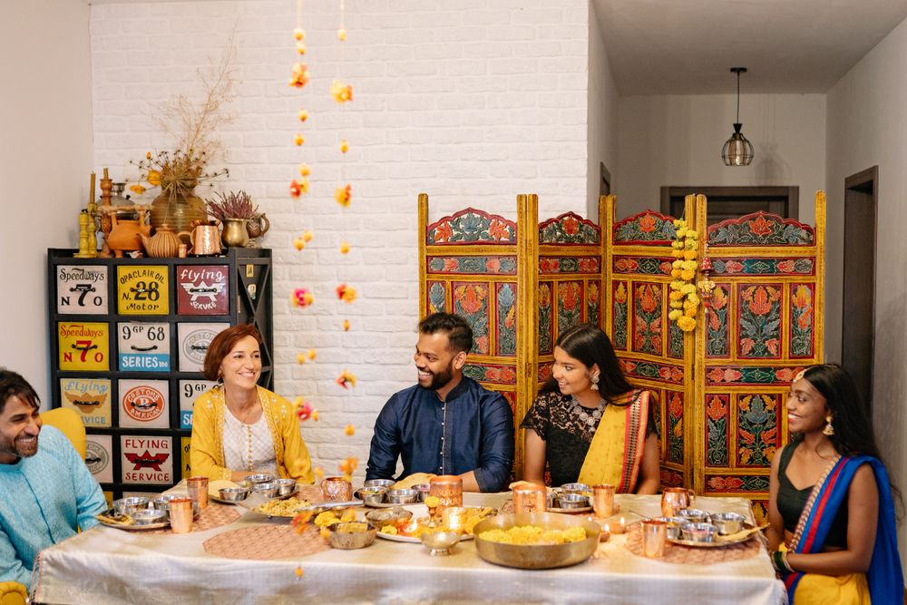 A family enjoying a long lunch at a table full of food